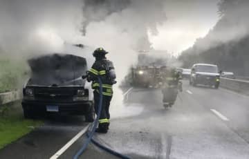 Fire crews tackled a burning engine in a cargo van during Monday morning rush hour on the Merritt Parkway in Fairfield.