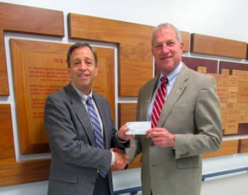 Shelton Mayor Mark Lauretti, right, hands a check for $5,000 to Kennendy Center CEO Martin Schwartz.