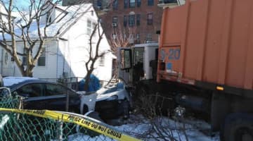 A Mount Vernon DPW truck went rogue, striking a car and damaging a house.