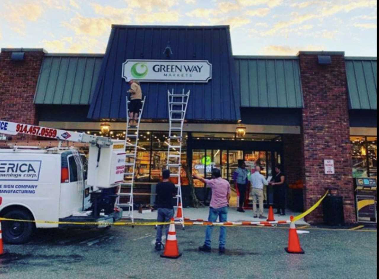 <p>The sign for the Green Way Market opening in Cross River goes up.</p>