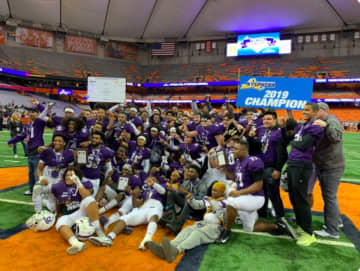 New Rochelle High School celebrates its 28-0 win over McQuaid of Rochester in the Class AA state title game in Syracuse on Saturday night, Nov. 30.