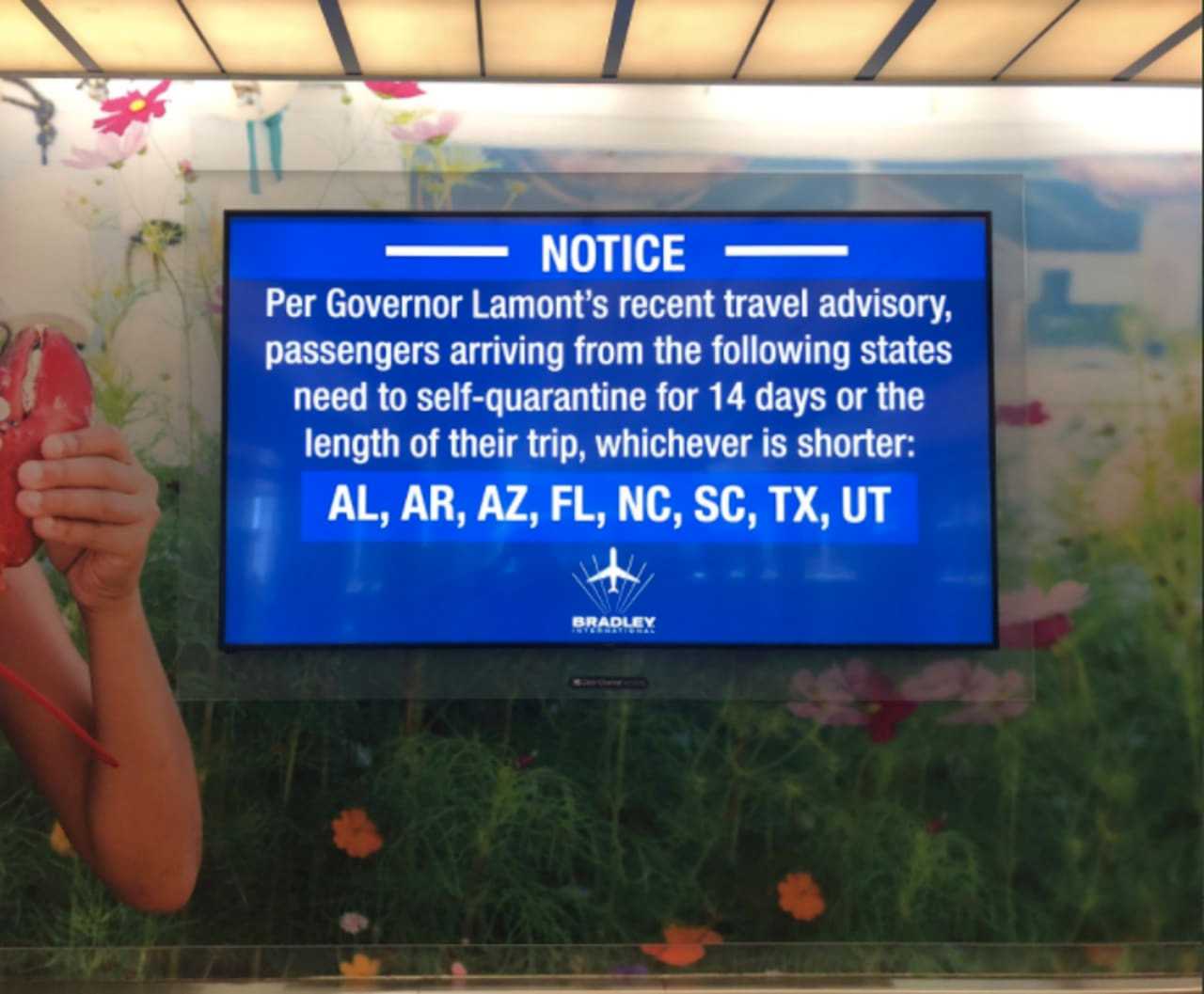 A sign at Bradley Airport in Windsor Locks, Connecticut announced the first quarantine order on June 25, which included the eight states shown.