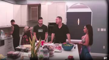 "Jersey Shore" cast members gather around the kitchen island in the Manalapan home where "Jersey Shore Family Vacation" was filmed.