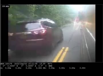 The SUV passed the stopped bus.