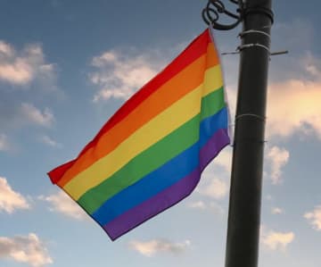 Hate signs with the words 'groomers' were placed under a Pride flag at Greenwich Town Hall just hours after a celebration kicking off Pride Month.