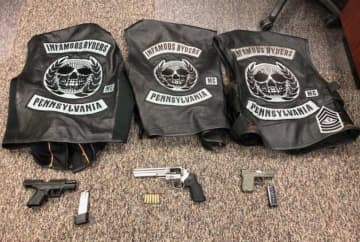 Some of the weapons and Infamous Ryders Motorcycle Gang jackets that were seized by the NY state police.
