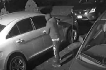 A burglar is caught on camera at 4:00 a.m. checking for unlocked car doors
in a Trumbull driveway recently.
