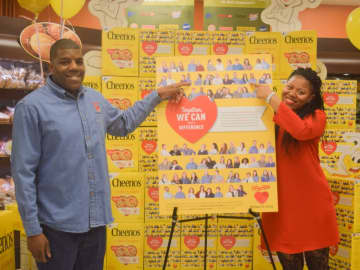 Tuckahoe ShopRite associates Michael Cabazas and Natasha Smith, who are both from Yonkers, point to their photos that appear on a special edition Cheerios box sold exclusively in ShopRite stores this month.