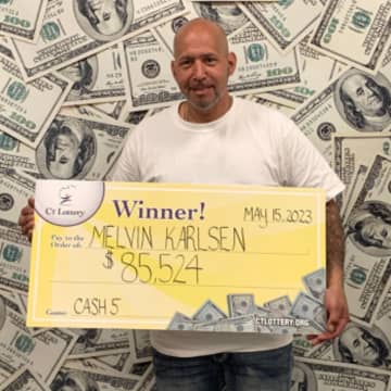 Melvin Karlsen showing off his 'big' check after winning two Cash5 lottery games.
