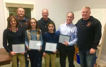 The Brosnan family holding their citations with members of the Weston Volunteer Fire Department.