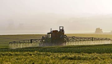 Weed killer being sprayed on a corn field.