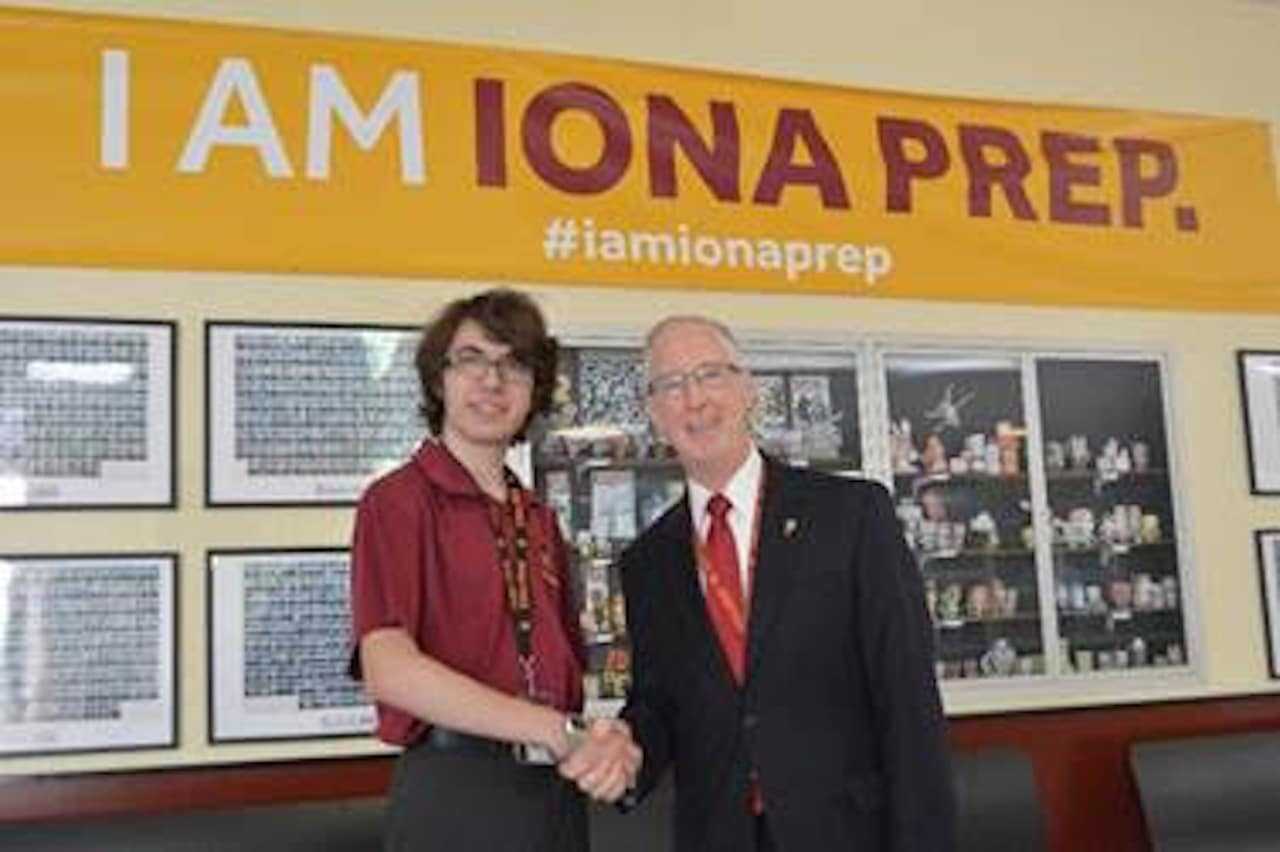 Brother Thomas R. Leto, president of Iona Prep in New Rochelle, congratulates Iain Pile of Tuckahoe,
a 2017 Semi-Finalist in the National Merit Program.