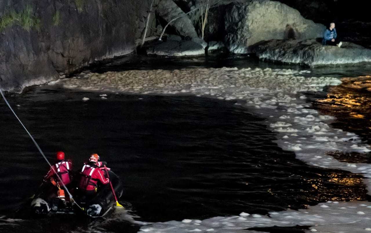 City firefighters head toward the man at the base of the Great Falls in Paterson.