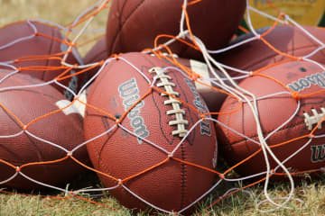 The footballs will stay in the bag for Connecticut high schools due to COVID-19.