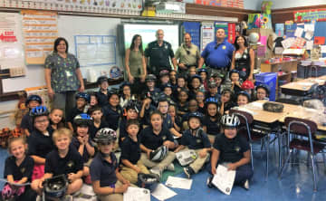 Garfield police officers brought helmets to the youngsters in the second-grade classes of Wioletta Zagorski and Tara Varna.