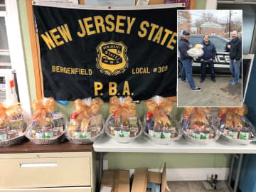 Members of Bergenfield PBA Local 309 assembled and delivered 10 Thanksgiving Day baskets for families in need. INSET (l. to r.): Officers Daynel Ozorio, Andre Enriquez, Tim Knapp.