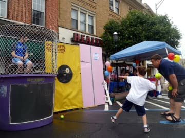 Six-year-old Charlie Carpenter takes aim at the dunk tank at last year's Ossining Village Fair.
