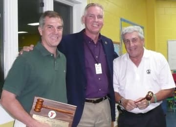 Wilton Family Y Executive Director Bob McDowell, center, greets Sean Carroll, past president of the Wilton Y Board of Directors, left, and newly elected board President Howard Steinberg, right.