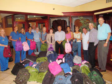 Workers collect fully stocked backpacks for children in Andrus programs,