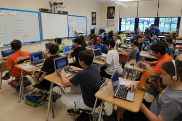 Tuckahoe Middle School students are shown using Chromebooks in the classroom.