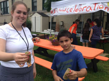 Christine Luciano and one of her students Kobe Sekhatme made salad wraps out of the herb plants they grew in the Mamaroneck Avenue School community garden. 