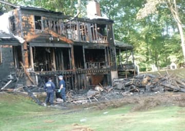 A home at 25 Bittersweet Lane in North Stamford was destroyed by an early morning fire Wednesday. The three occupants escaped. The cause is under investigation.