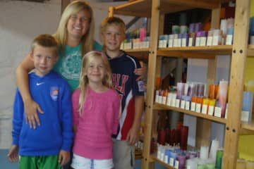 Jenn Heatly of Norwalk, with her children (from left) Pace, 9; Bell, 7; and Landon, 11, runs a candle-making business of her home. 