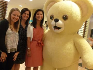 Snuggle Bear, mascot for Wilton-based Sun Products Corp.'s line of fabric softeners, celebrates his 30th birthday Monday. From left from Sun Products are: Jessica Davidson, Sarah Mayer and vice president Bibie Wu.