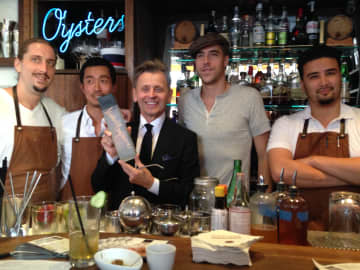 Mikhail Baryshnikov poses with the mixologists who created drinks in his honor using Slovenia vodka.