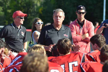 New Canaan football coach Lou Marinelli speaks with his team after winning his 300th career game Saturday against Greenwich.