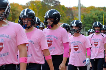 John Jay High School football players wear pink shirts for Breast Cancer Awareness Month.