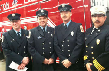 Wilton Fire Department firefighters from left, Brian Elliott, Kevin Plank, Ralph Nathanson and Deputy Chief Mark Amatrudo, Ralph Nathanson, stand in front of Engine 4, the new addition to the department's fleet, following a ceremony Wednesday.