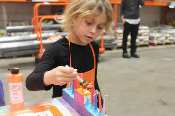 Children enjoyed building and painting  wood menorahs at The Home Depot in New Rochelle.