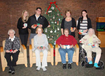 Pennyweights owners Kelly and Geoff Sigg present residents with some of the many donated gifts alongside Wavenys directors of therapeutic recreation, Patty Pasquarella and Lauren Elker.