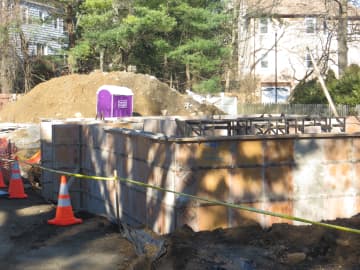 A hole surrounding a new foundation was cordoned off with cones and caution tape Saturday where a car fell in Friday night.
