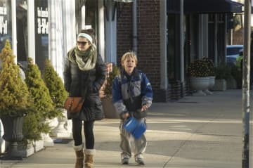 Residents try to stay warm on the streets of Mamaroneck.