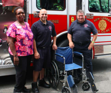 Waveny LifeCare Network recently donated a wheelchair for New Canaan firefighters to use for training purposes. Yolette Milford, left, a Waveny rehab assistant, presented the gift to the New Canaan Fire Department.