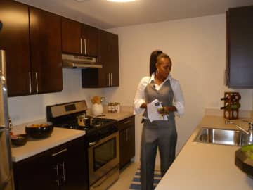 Megan Martin inspects a model apartment in the affordable housing complex unveiled Thursday at 49 N. Broadway. Martin will be one of the tenants in the building when it opens later this fall.