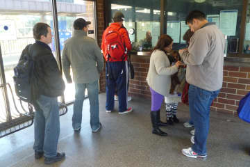 People wait in line at the White Plains Train Station days after Hurricane Sandy struck the region.