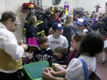 Kids enjoy the magic show at last week's Halloween party at the Pound Ridge Firehouse.