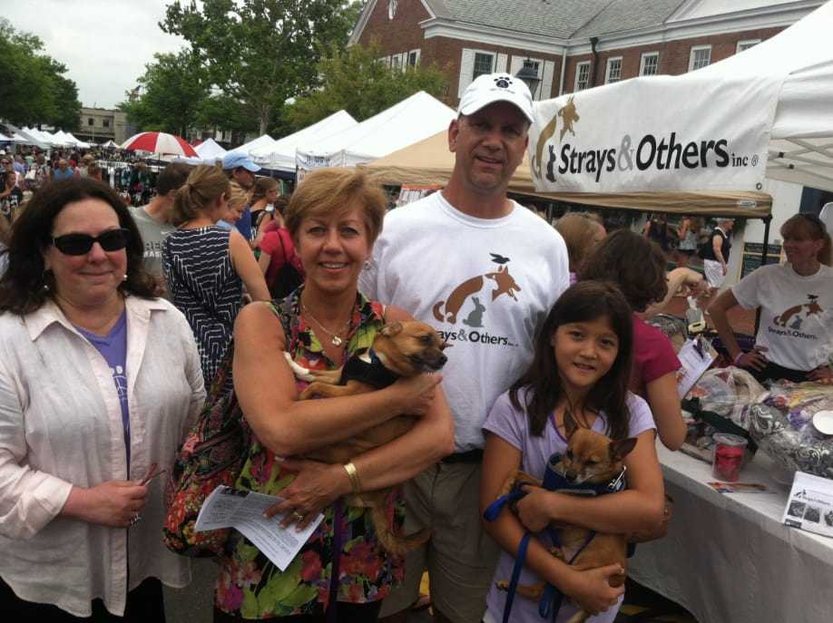 From left: Claudia Weber, Lia Toth with 'Peewee,' Claude Colabella, and Charlotte Frank holding 'Pookie" outside the Strays & Others tent at the New Canaan sidewalk sale Saturday.