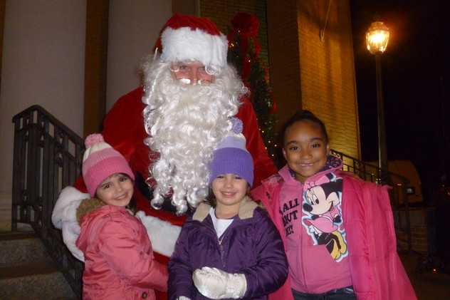 Madelyn, left, and Kaitlyn Dwyer, center, along with Jayla Odtis help welcome Santa last year at the festivities in Depot Square in Tuckahoe.