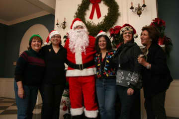 Santa Claus with members of the then Eastchester-Tuckahoe Chamber of Commerce in 2012. He has made annual trips to town since 2008.