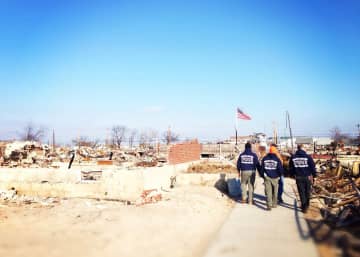 Members of the Venture Crew from Lewisboro walk through the rubble in Breezy Point left by Hurricane Sandy.