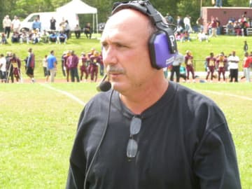 New Rochelle football coach Lou DiRienzo will not face criminal charges as the investigation continues.