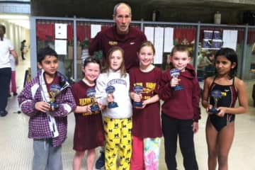 Wilton Wahoo swimmers show trophies they won last week at a meet in New Haven. The swimmers are (left to right) Dev Madhavani ,Whitney Hess ,Hailey Brooks , Emily Bukowski, Justin Lewis and Anya Iyer. They are with coach Bert Boardman.
