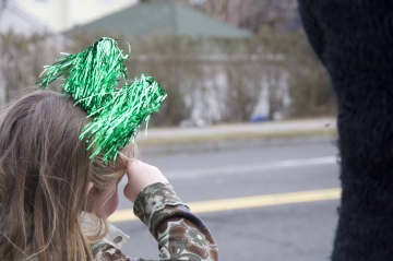 One young parade goer salutes the police department as it approaches.