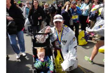 Michael Leonard, pictured with his son Alexander, is among the Boston Marathoners who escaped injury.