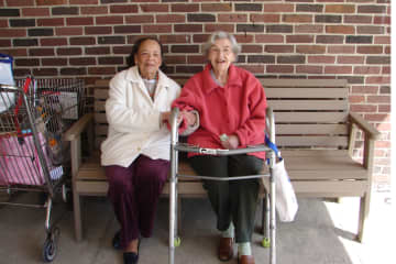 Phyllis Shearer and Dorothy MacLean sit on the new Pound Ridge senior citizens bench.