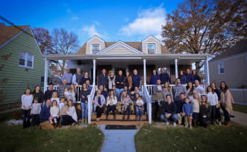 The Belthoff family's photo has been in the work for six months. Robert "Bob" Belthoff stands at the top of the stairs in the middle.